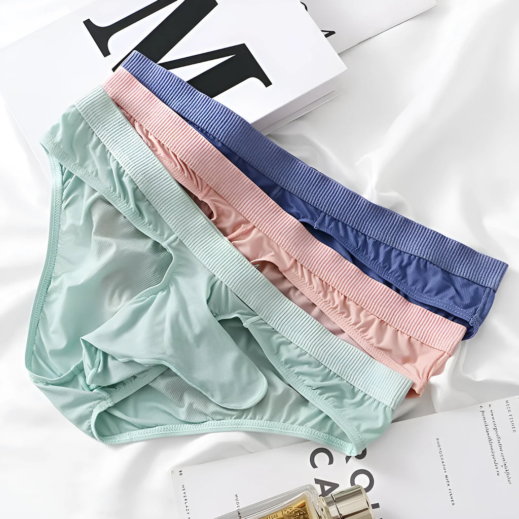 Men's low waist briefs underwear in ice silk fabric on a colour swatch showing black, grey, blue, green, and pink.
