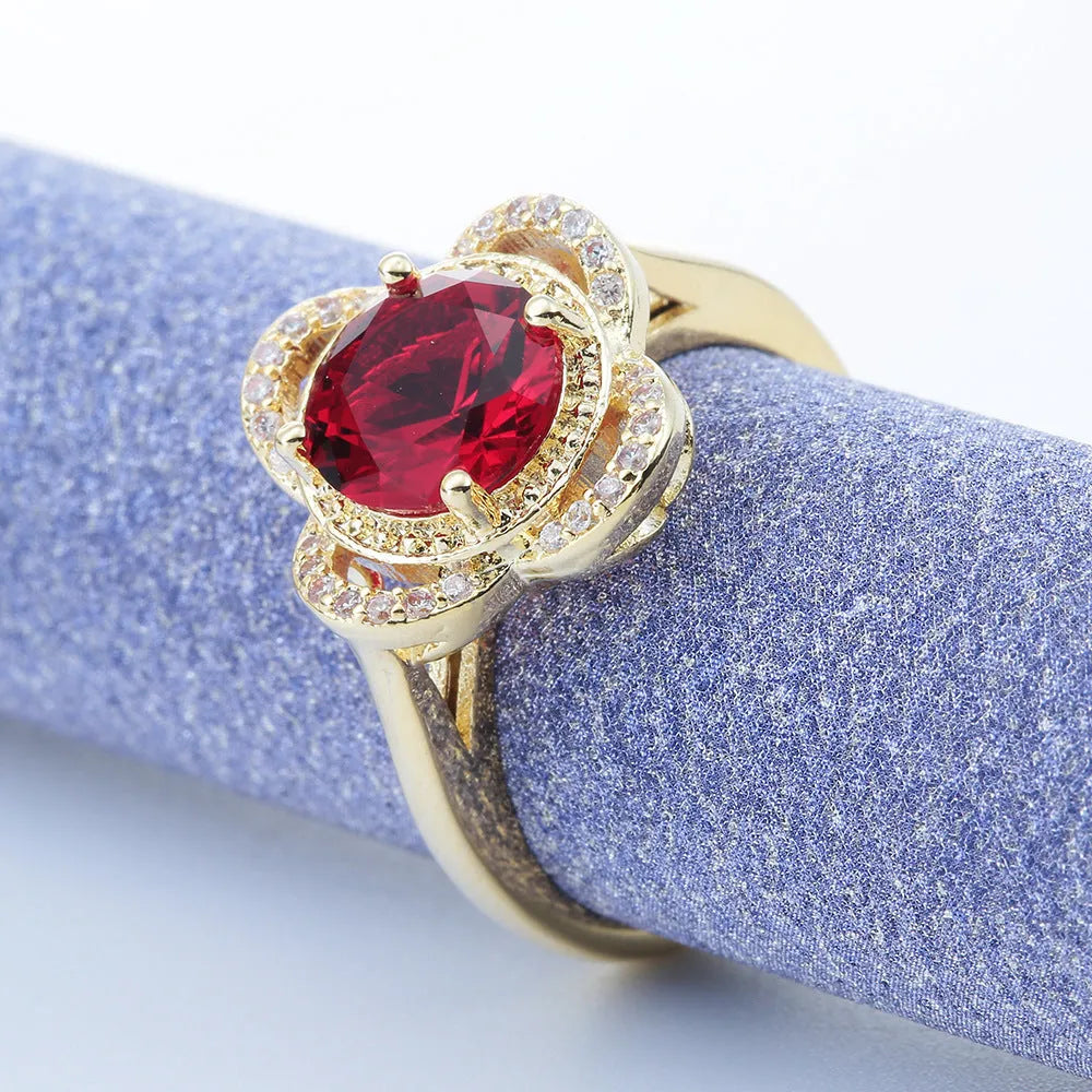 Copper ring with a fruit shape design and zircon stone inlays on a hand.