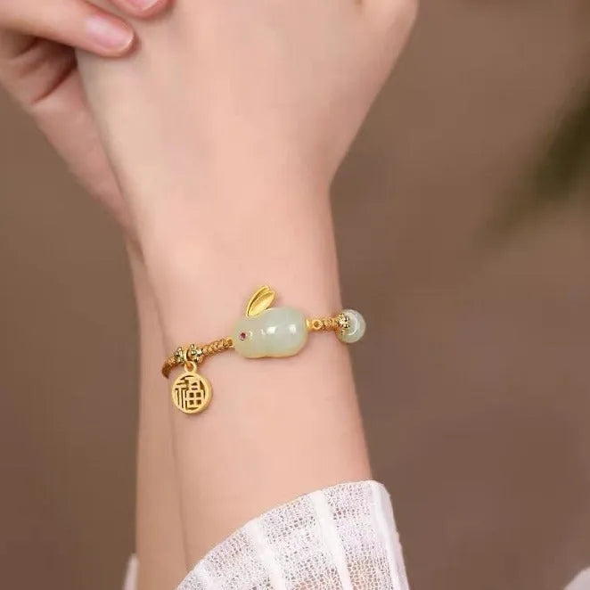 Hetian jade geometric rabbit charm bracelet on a yellow string for women.
