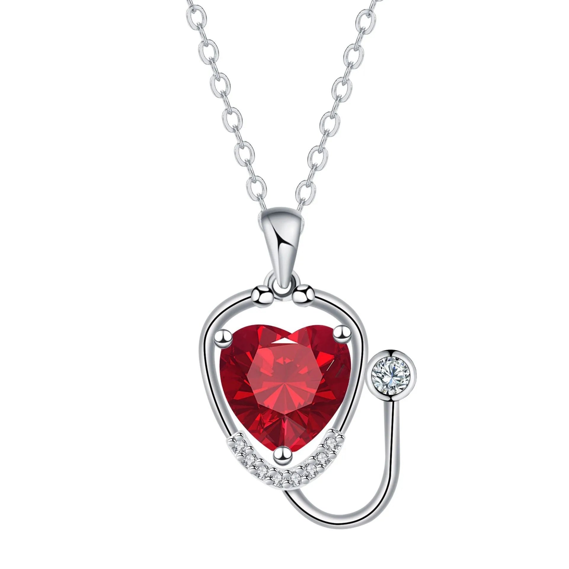 Red diamond stethoscope necklace with a wing and cross pendant on a chain.