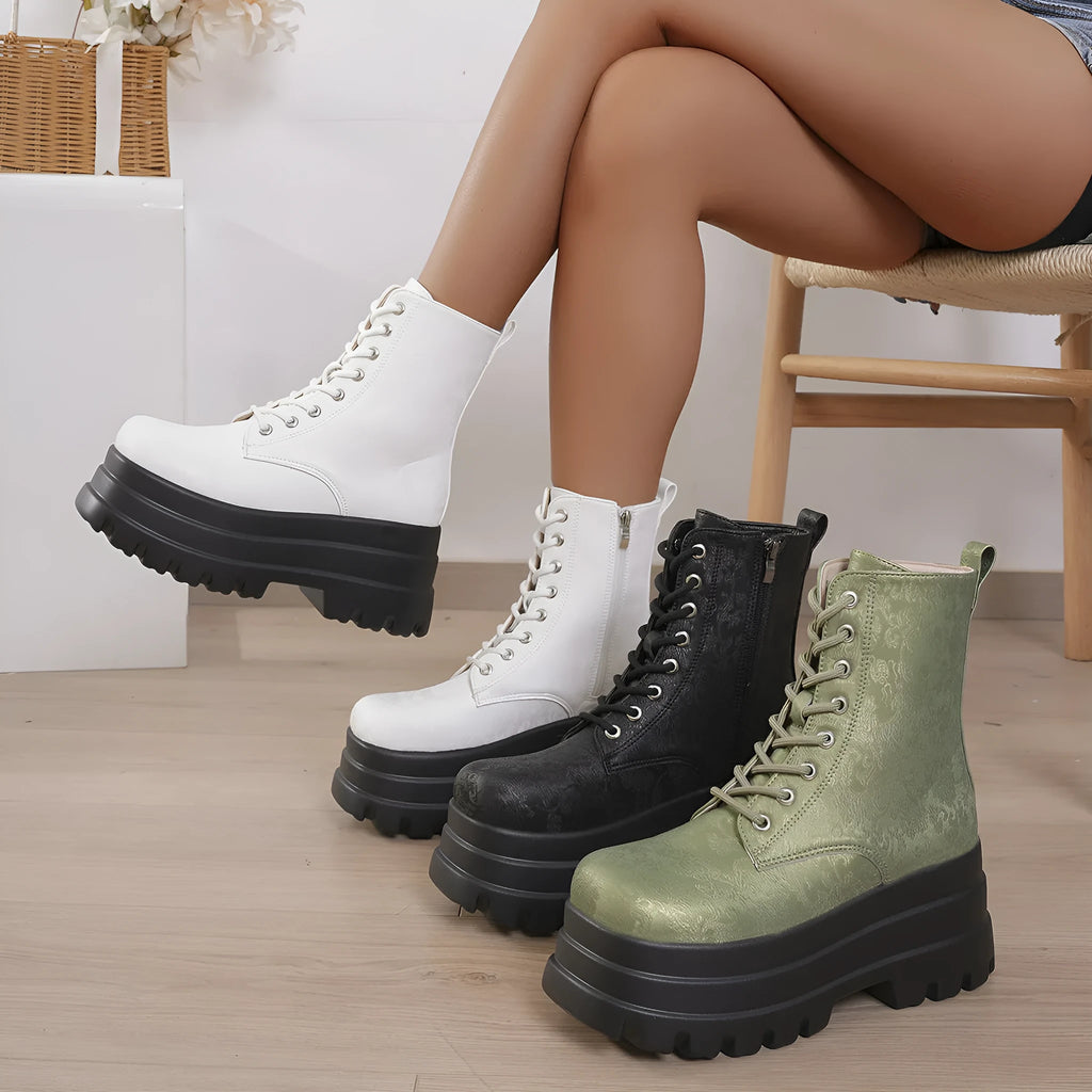 Women's black platform Martin boots with side zip and chunky rubber sole.