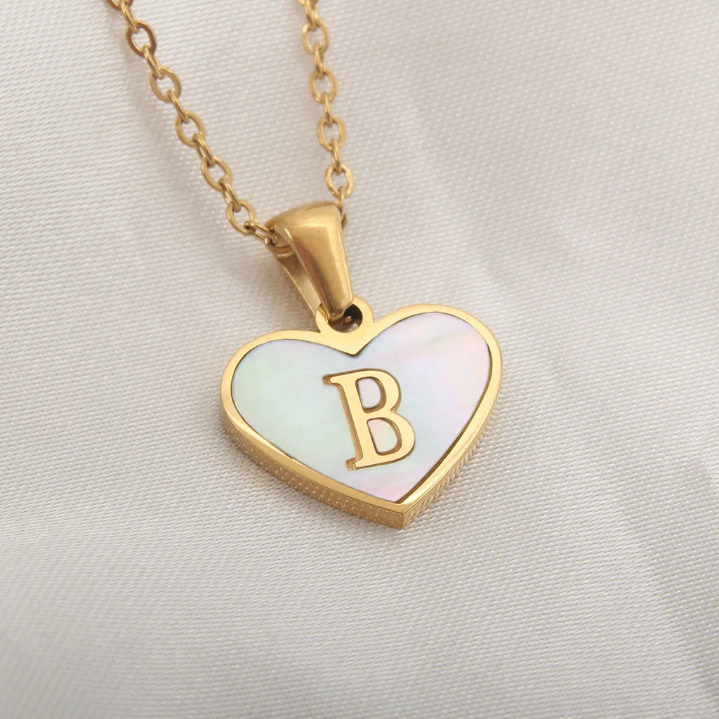 Gold plated chain necklace with a white shell heart-shaped pendant personalised with a single letter initial.