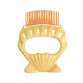 Shell-shaped pet grooming brush with bent wire bristles in green, orange and purple colour options