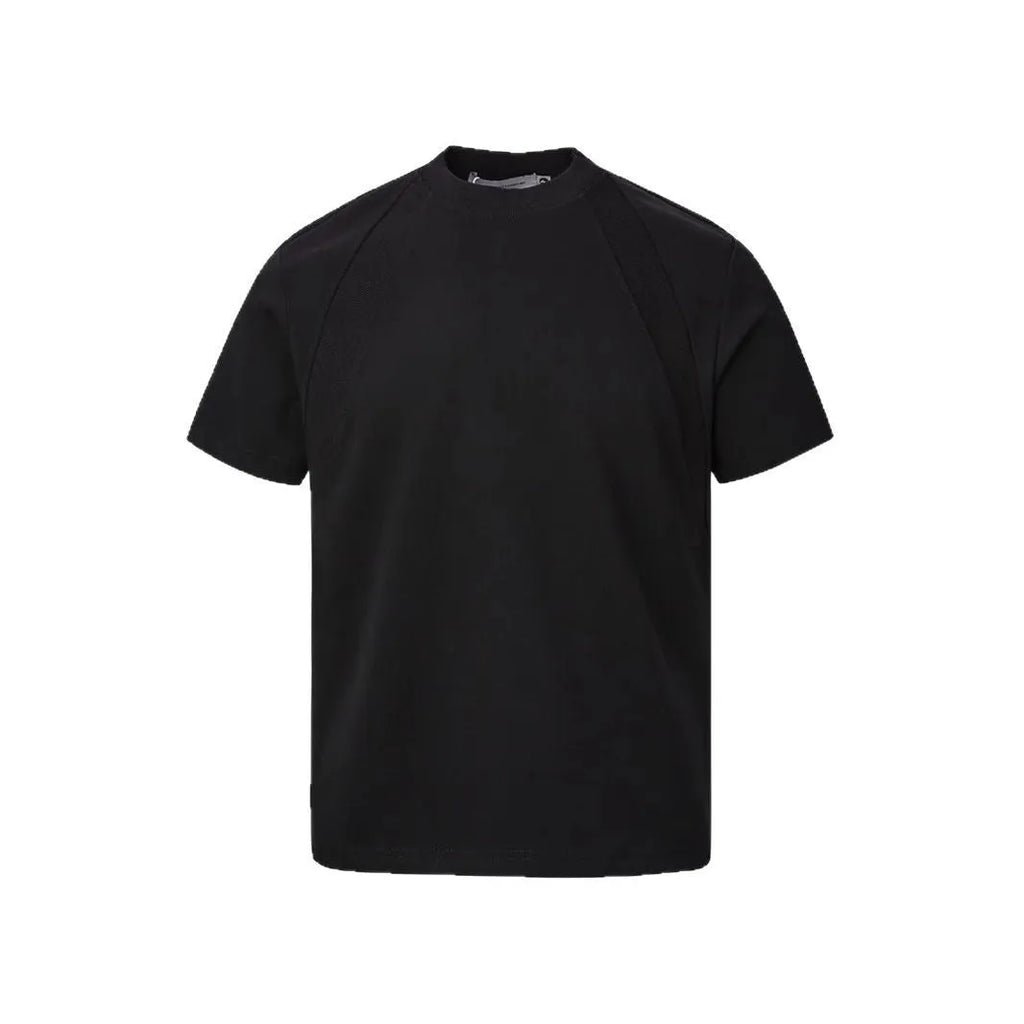 Man wearing a loose-fit black short sleeve top with visible air layer stitching detail.