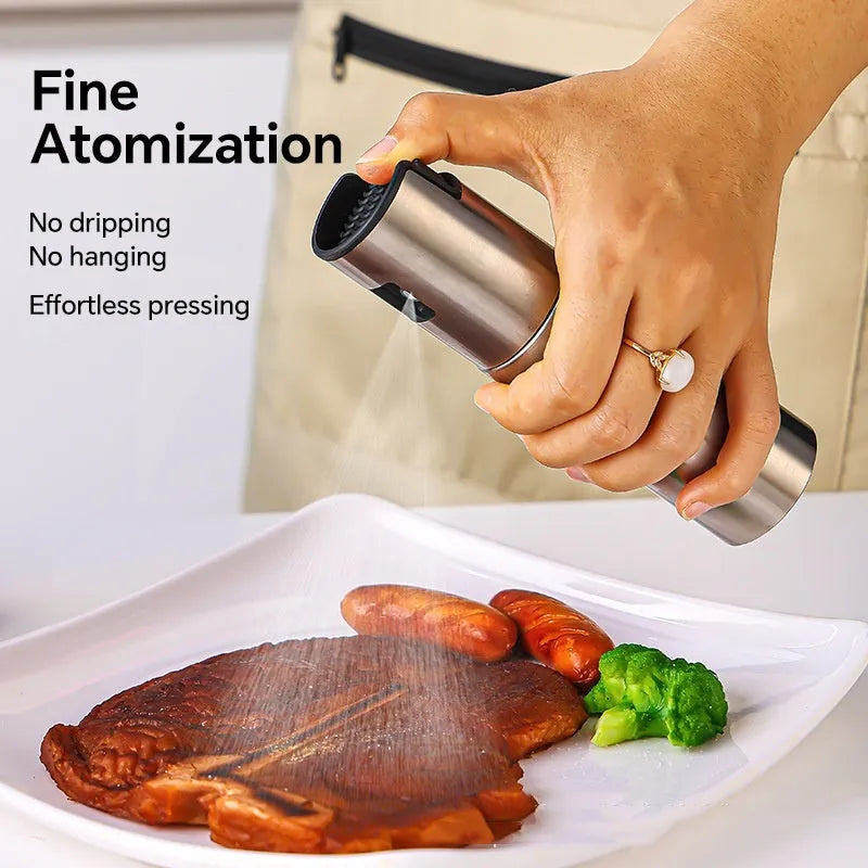 Press-type stainless steel oil spray bottle with 100ml capacity and glass body for kitchen use