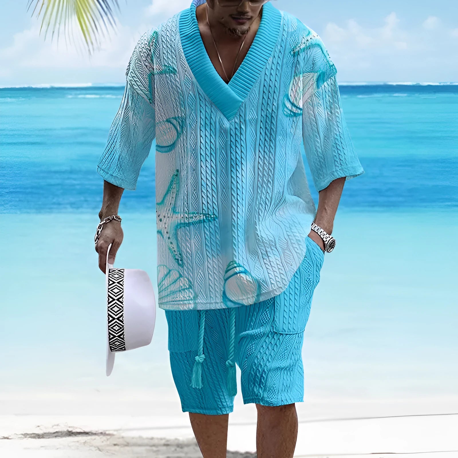 Man wearing a loose-fitting casual short sleeve suit with matching shorts in a solid colour.