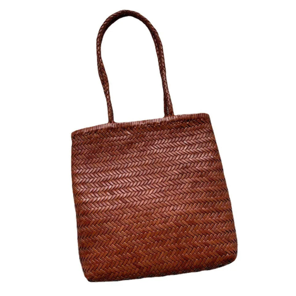 Brown handmade vintage woven leather tote bag with three-dimensional outer pockets.
