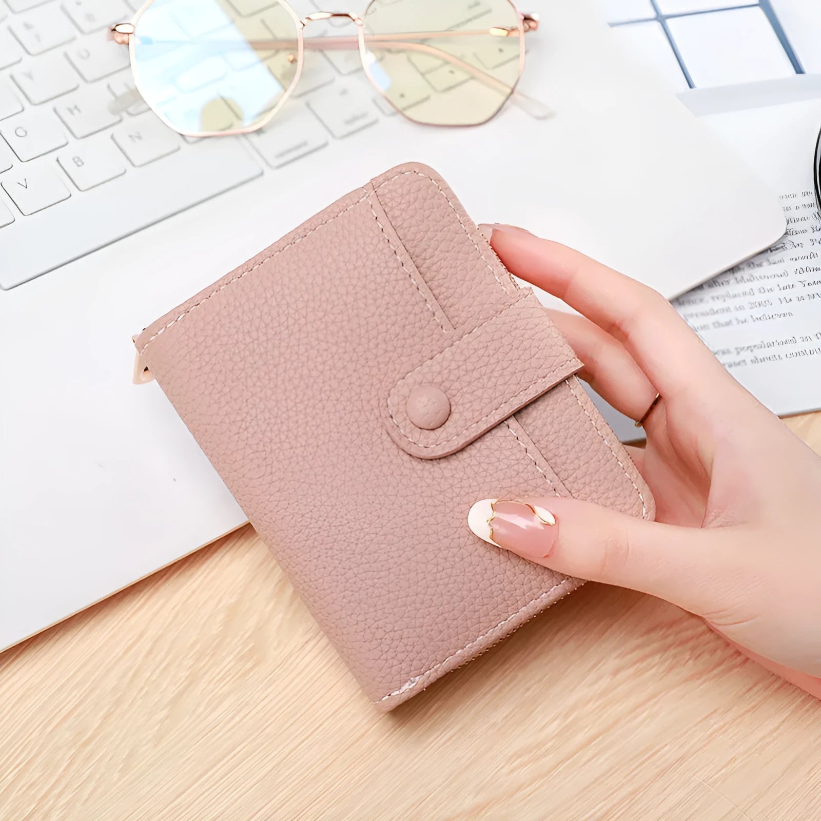 Beige ladies short wallet with a textured lychee pattern, shown in a two-fold open position.
