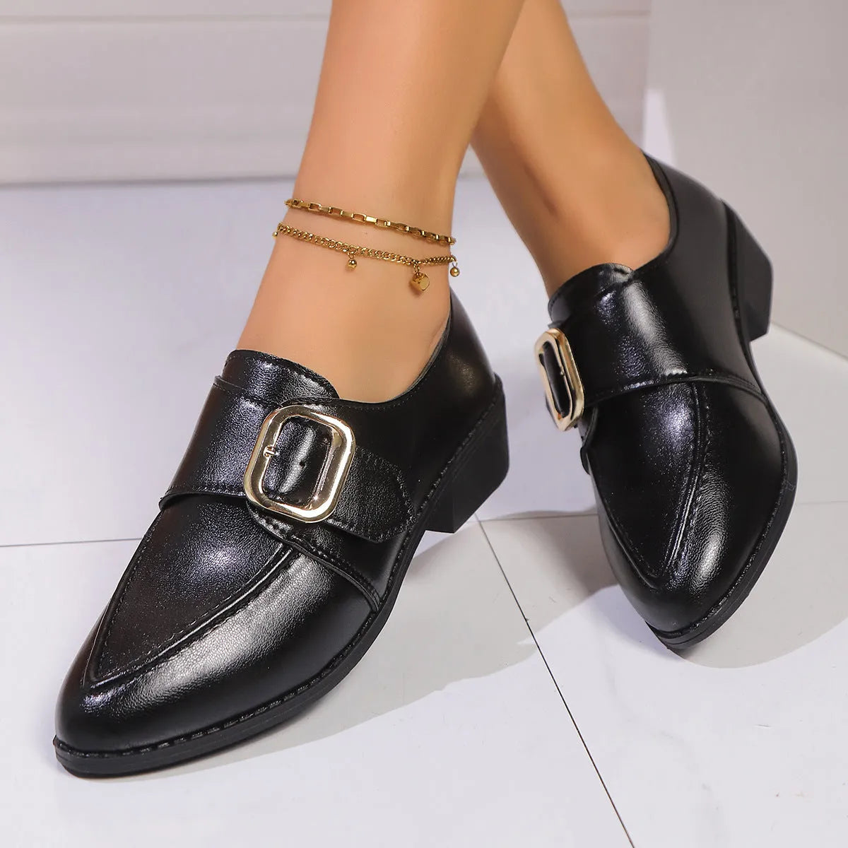 Women's classic black slip-on flat shoes with a large decorative bow on the toe.