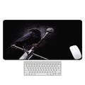 Large patterned desk mat for mouse and keyboard on a wooden desk.