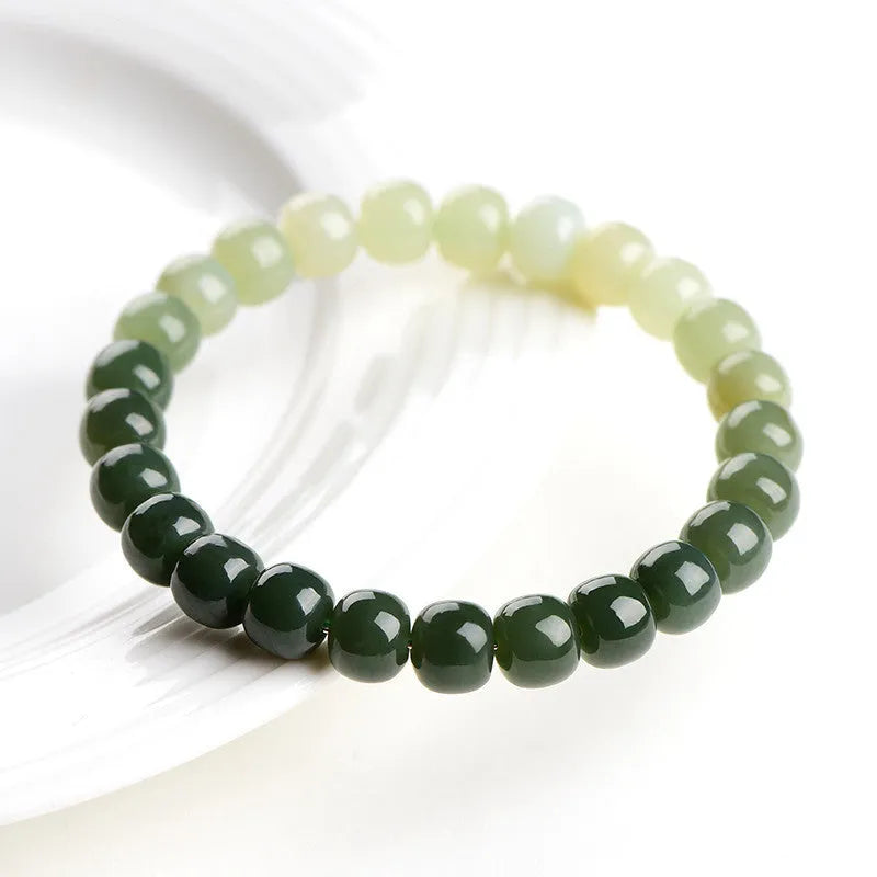 Polished Hetian Jade bracelet showing a gradient water colour on beads.
