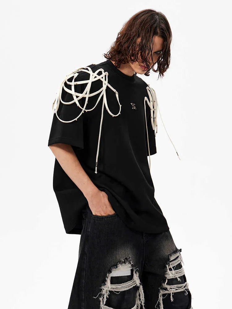 Black women's short-sleeved T-shirt with padded shoulders and rivet ribbon detail.