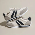Low top lace-up running sneakers in red or blue with mesh upper and rubber sole