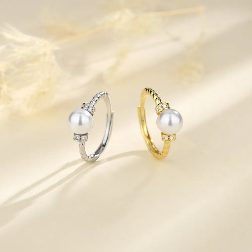 Adjustable antique twist design copper ring with pearl inlay in gold colour.