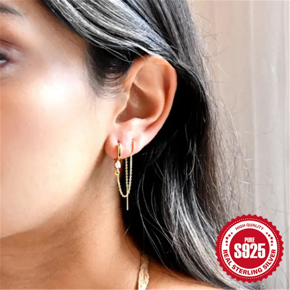 S925 sterling silver geometric drop earring with flower and tassel chain detail in a golden colour.