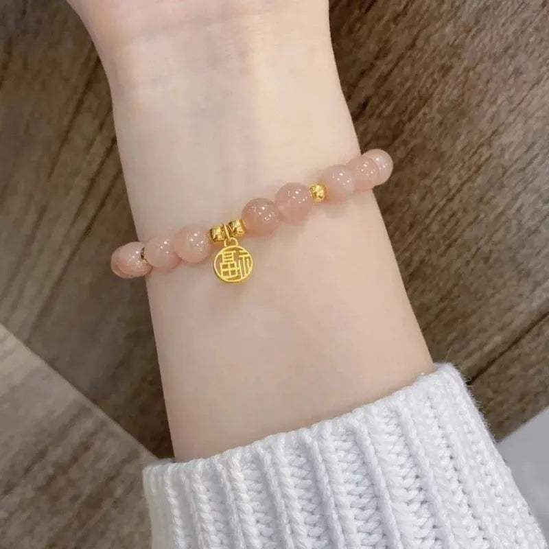 Chinese style glass bead bracelet with bamboo leaf design and manual craftsmanship details.