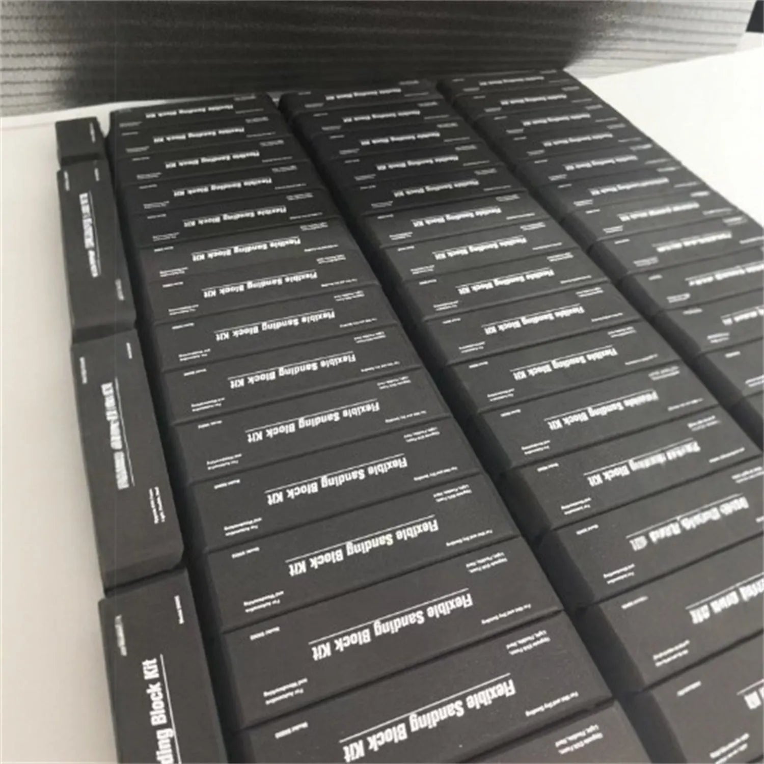 Seven black EVA frosted metal blocks arranged as a set