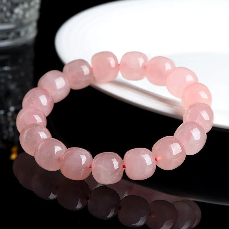 Pink natural crystal bracelet with barrel-shaped 8x10mm beads in a geometric design.