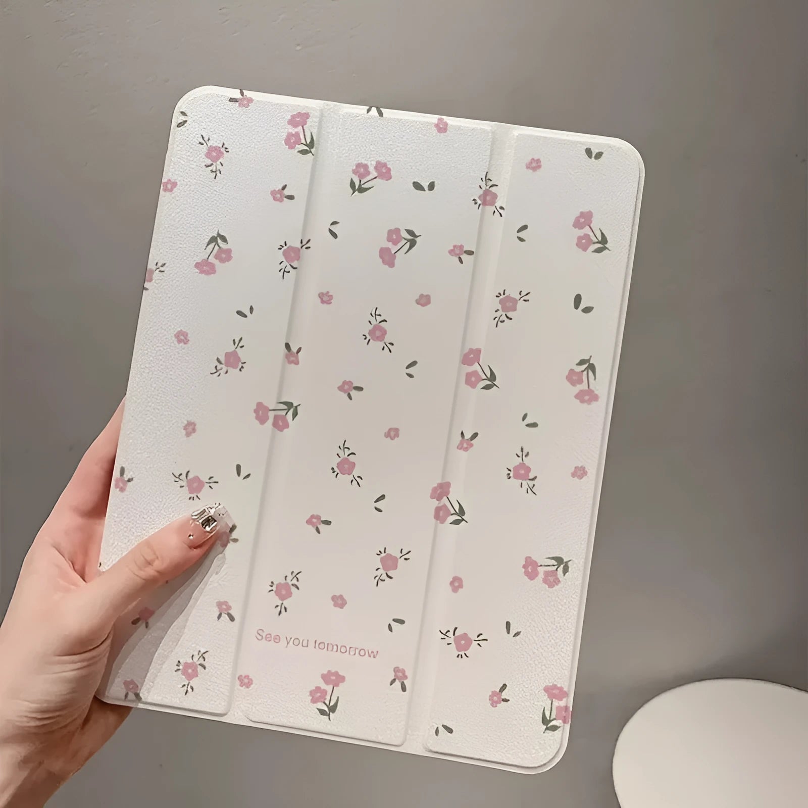 Transparent floral tri-fold iPad case with magnetic kickstand open in viewing position