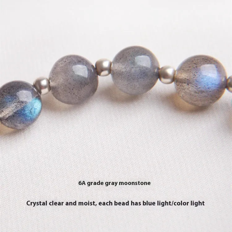 Women's silver bracelet with grey moonstone and zodiac charm.
