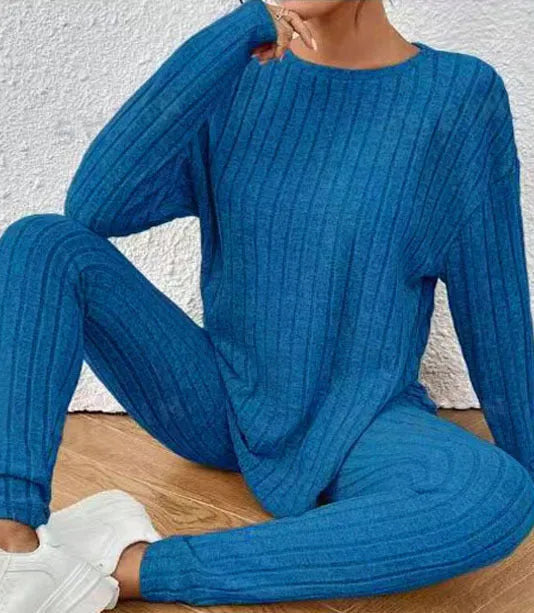 Black sunken stripe pattern two-piece loungewear set with regular sleeves on a hanger.