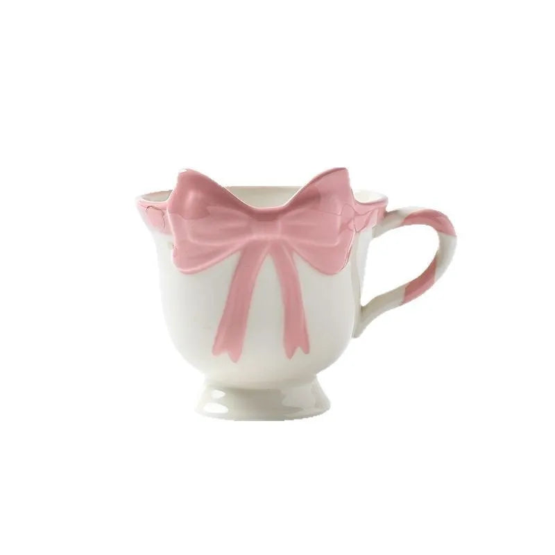 Ceramic mug with a cute girl heart bow design in black pink and white powder colours.