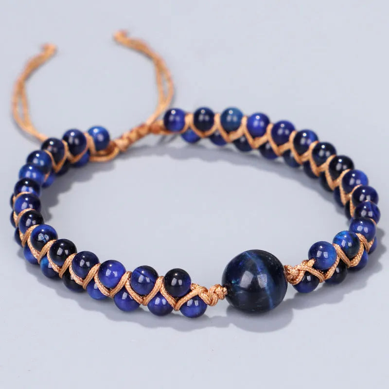 Close-up of a handmade woven bracelet with geometric tiger eye beads on an adjustable band.