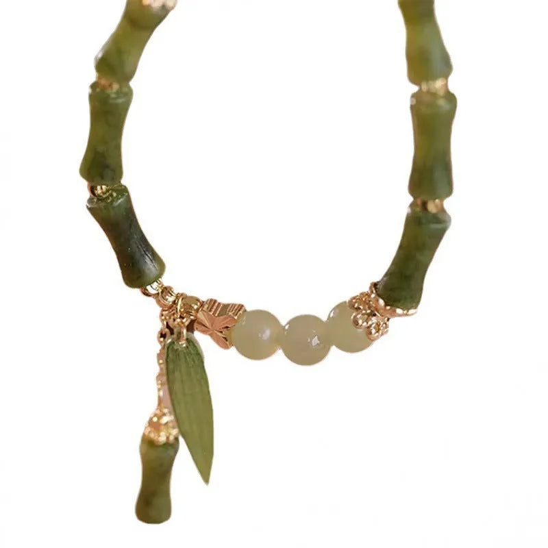 Chinese style glass bracelet with bamboo joint elements in red Lvzhu Duobao design