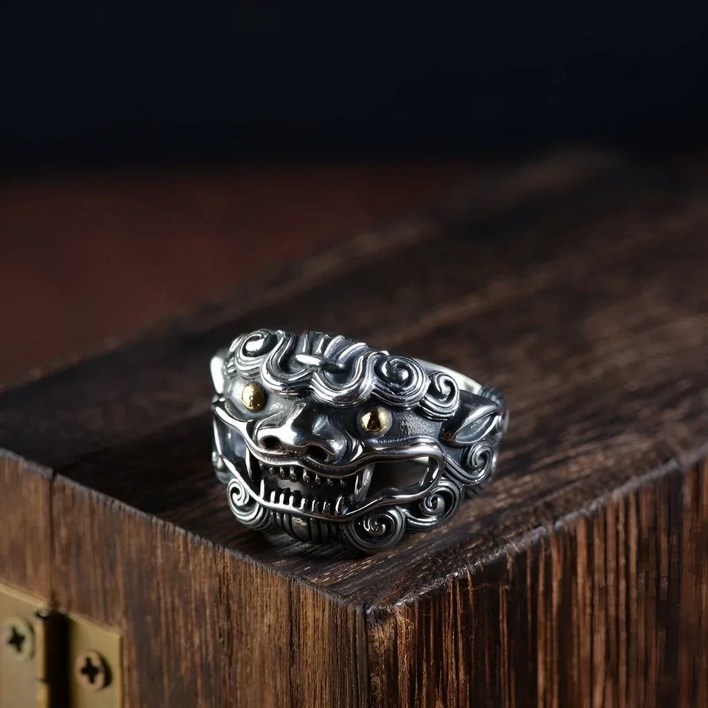 Silver open ring with detailed Jibeast and zodiac animal pattern, shown on a hand.