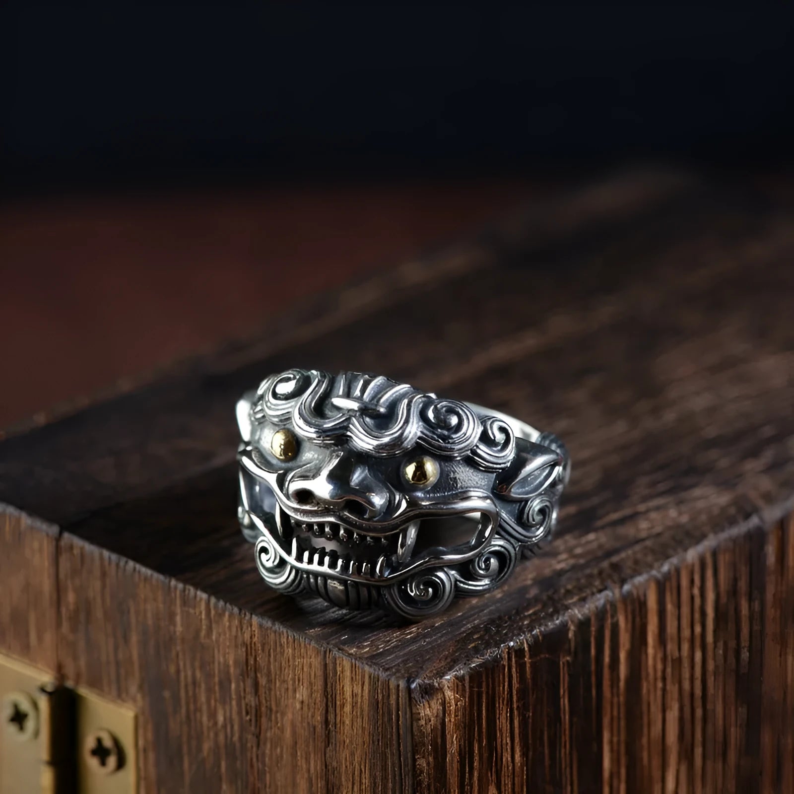Silver open ring with detailed Jibeast and zodiac animal pattern, shown on a hand.