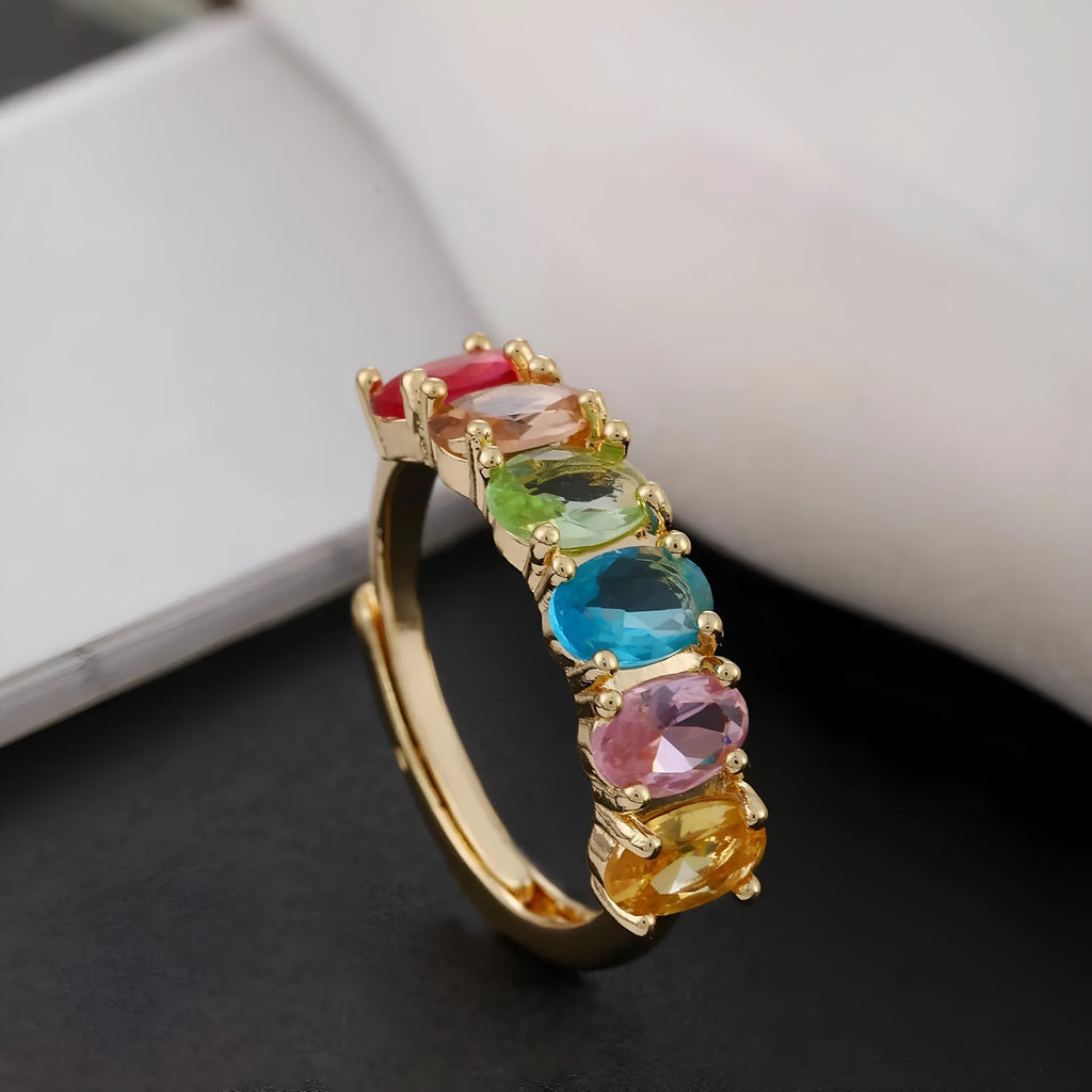 Gold-coloured adjustable zircon ring with simple retro design on a white background