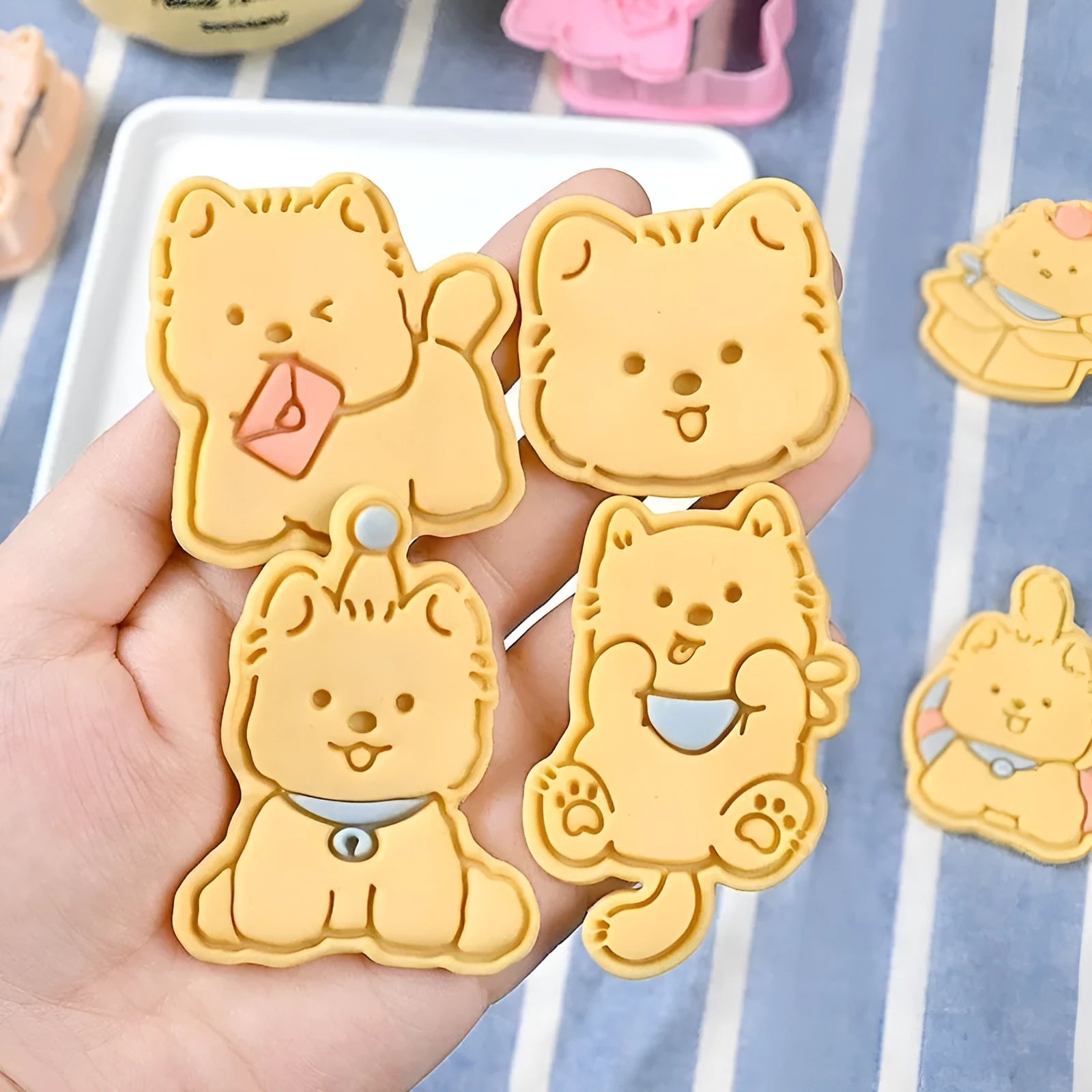 Plastic press mould for making puppy-shaped biscuits and soft candies with cartoon designs.