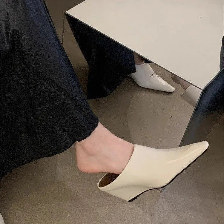 Women's black wind wedge style half slippers with closed toe, made from PU material.
