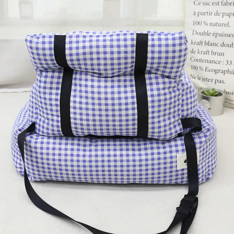 Grey and blue plaid portable dog car travel nest with stain-resistant cloth fabric.
