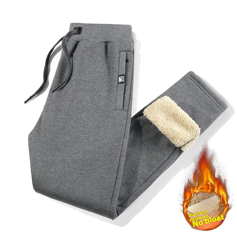 Men's grey fleece-lined cotton track pants with an elasticated waistband and drawstring, shown in an oversized fit.