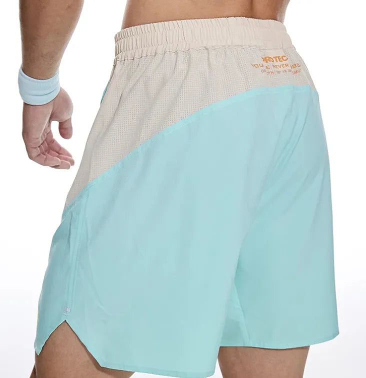 Man's loose grey workout shorts with elastic waist and lace-up fly for gym training