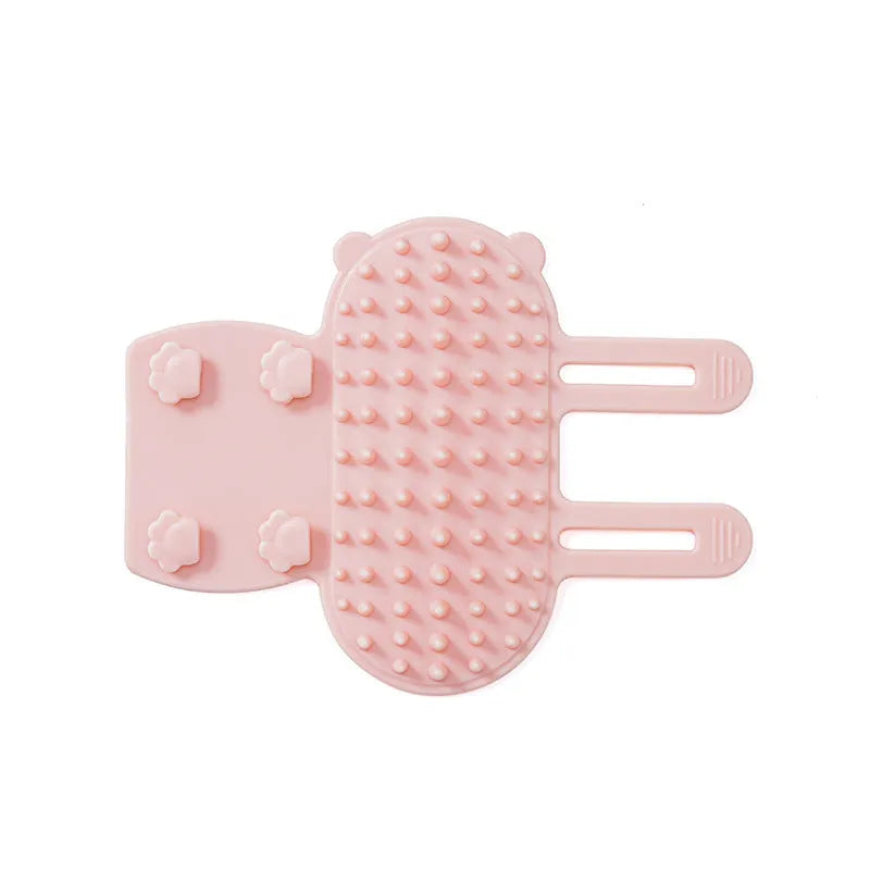 Silicone cat grooming massage comb with adjustable strap mounted on a table leg.
