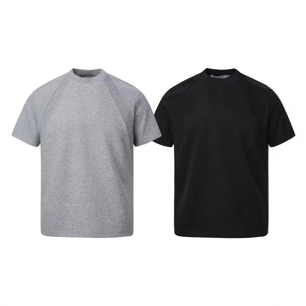 Man wearing a loose-fit black short sleeve top with visible air layer stitching detail.