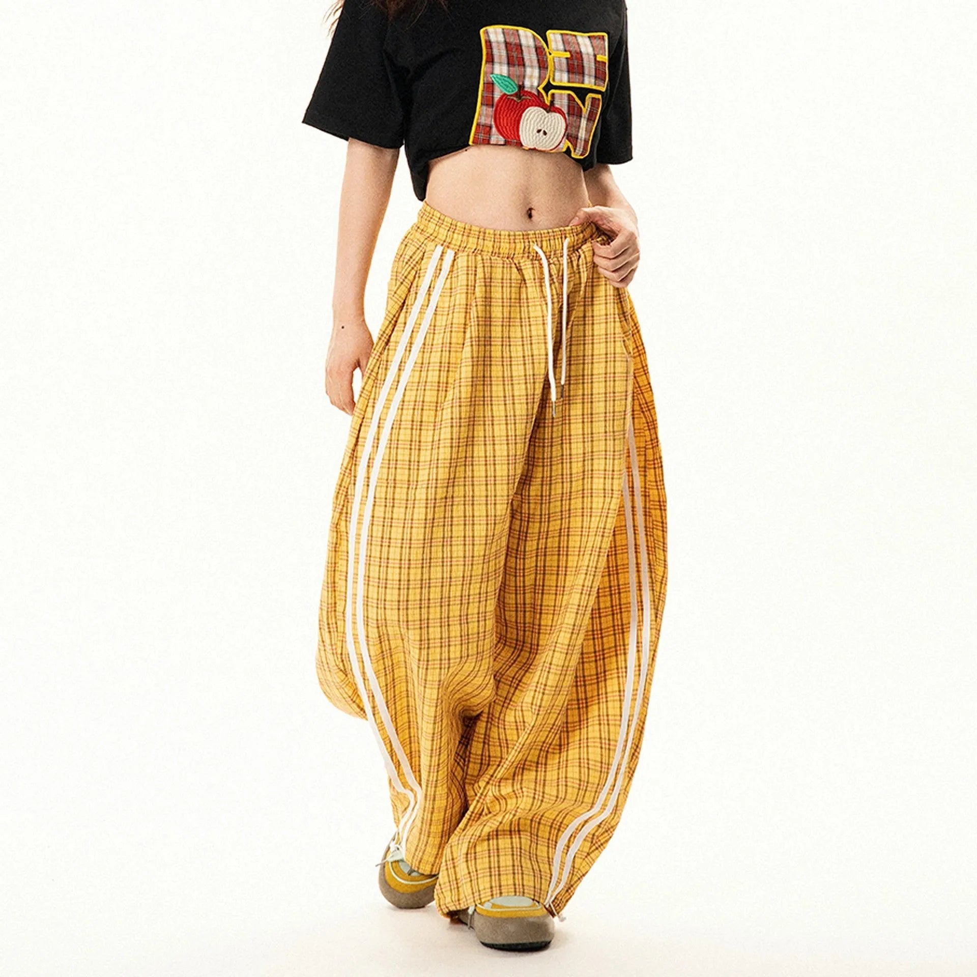 Blue loose straight wide leg polyester trousers with pockets and mid-waist design on a model