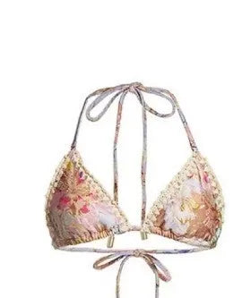 Women's creamy white floral bikini set with halter top, briefs, and a detachable ruffled skirt.