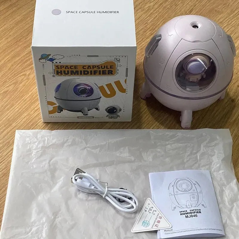 Light purple astronaut-shaped desktop USB humidifier with LED lights on a desk