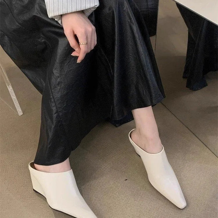Women's black wind wedge style half slippers with closed toe, made from PU material.