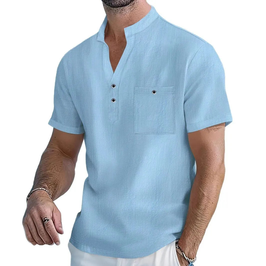 Man wearing a light-coloured linen stand collar short sleeve shirt in a loose fit.