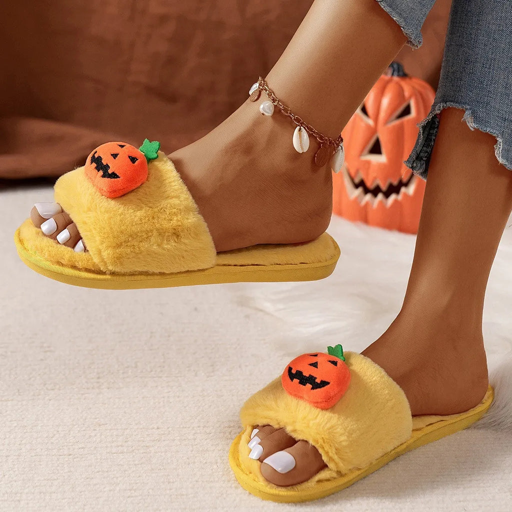 Yellow cartoon pumpkin plush slippers with open toe and anti-slip sole on a white background.