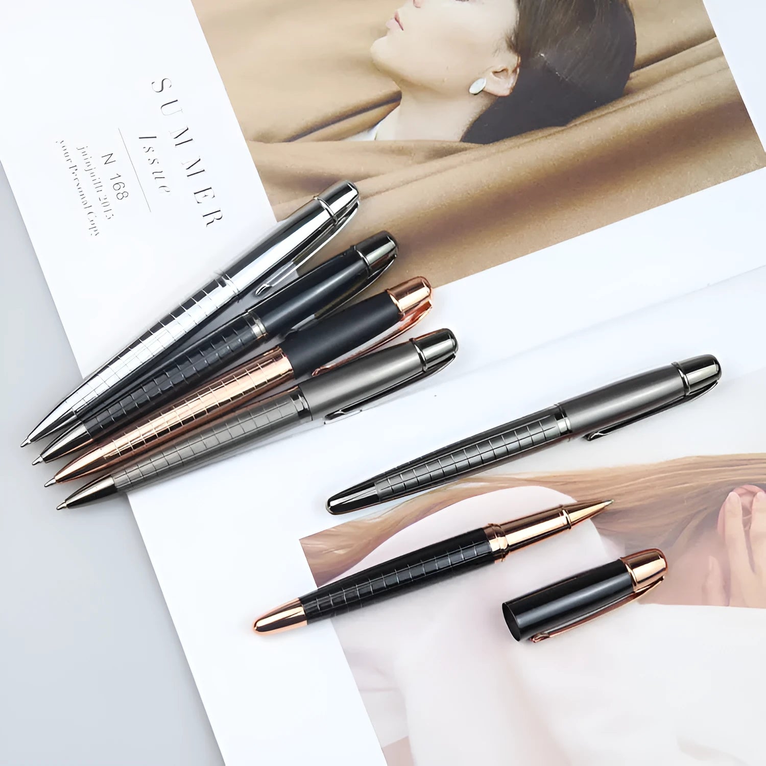 Grey metal retractable roller pen for business signatures on a white background.