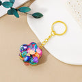 Small crystal cat's paw keychain pendant on a keyring, shown in various gemstone colour options.