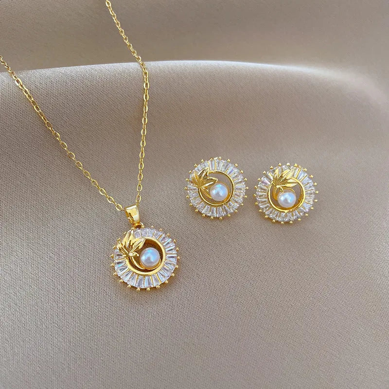 Geometric fashion jewellery set with gold plated copper detailing on titanium steel chain