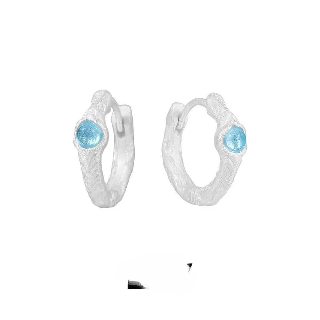 Geometric burnt silver ear clip for women made from 925 silver with round design elements.