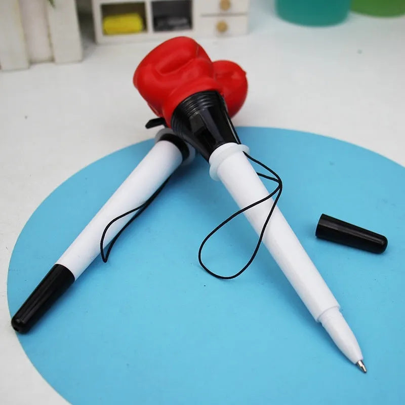 Four black boxing press ejection pens with a bullet-shaped 0.7mm tip on a desk.