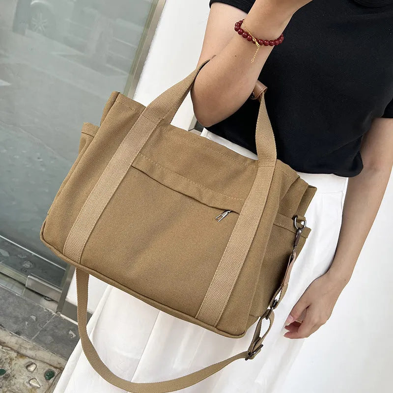 Large canvas tote bag with multiple internal compartments in horizontal square design